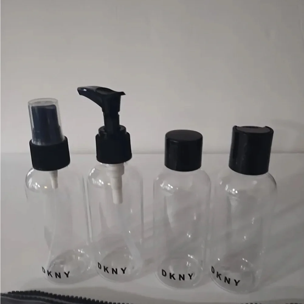 DKNY Clear Travel Bottle Set with White/Silver Pouch and Black Accents